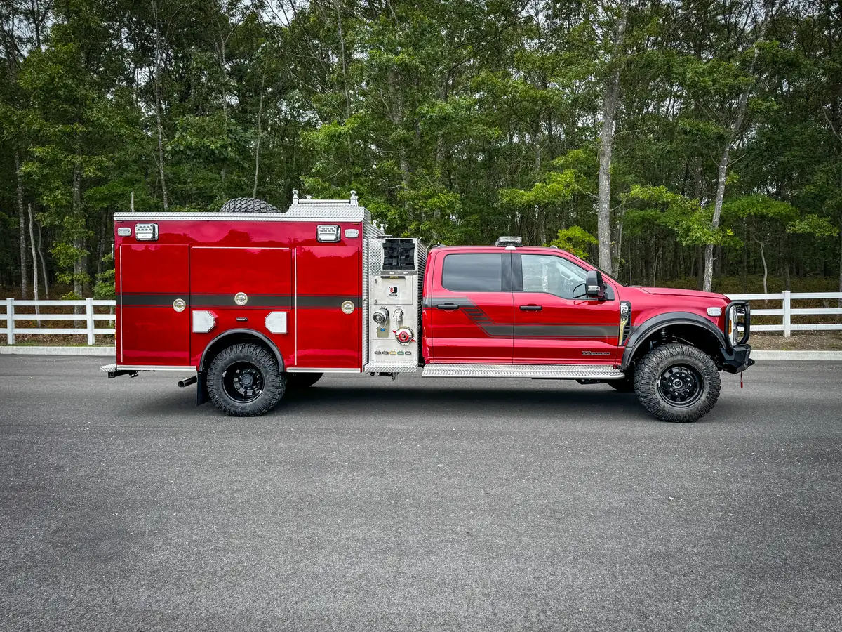 Right-side profile view with side body compartments and wheel/tire area visible.